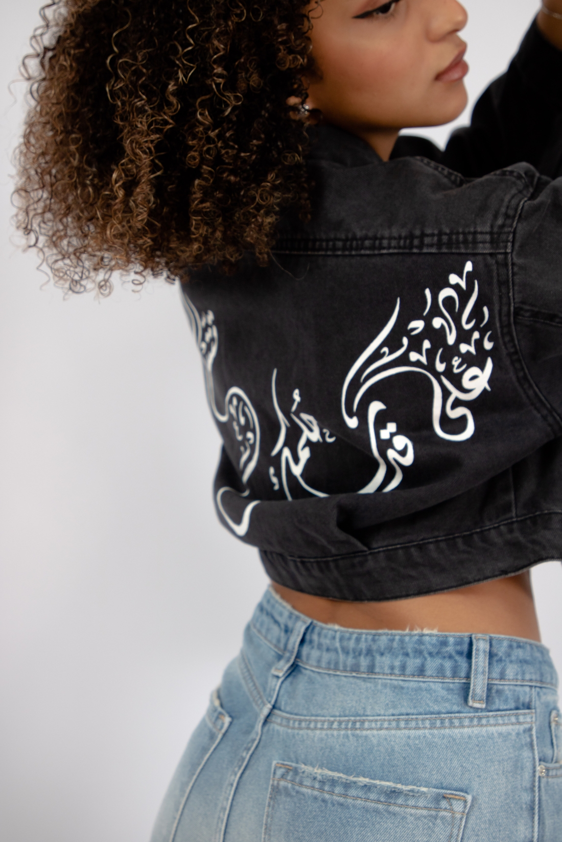 Exclusive denim jacket in black wash with hand-painted Arabic Calligraphy